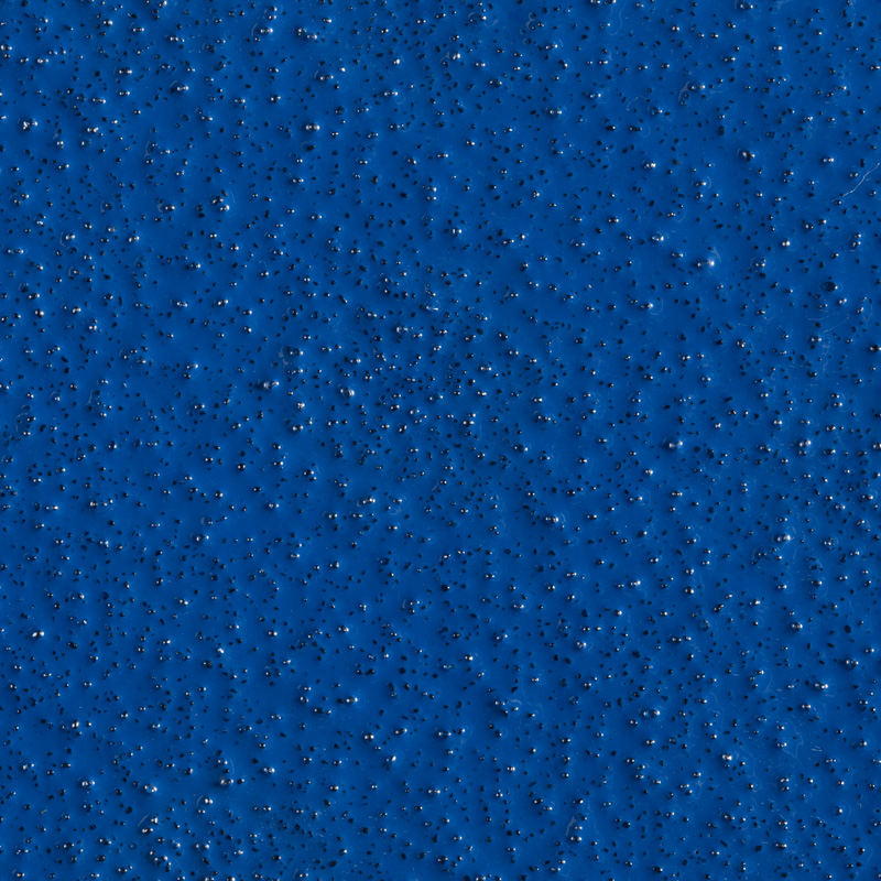 Close-up of a blue textured surface with small raised bumps evenly spread across the image.