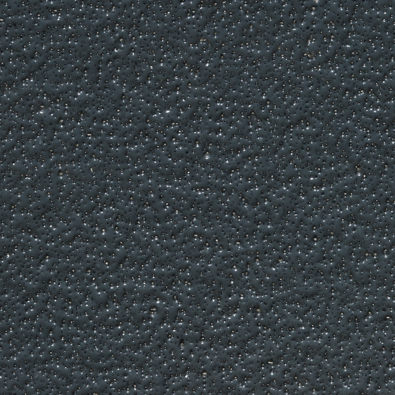 Close-up of a textured dark gray surface with small, uneven bumps and shiny specks scattered throughout.