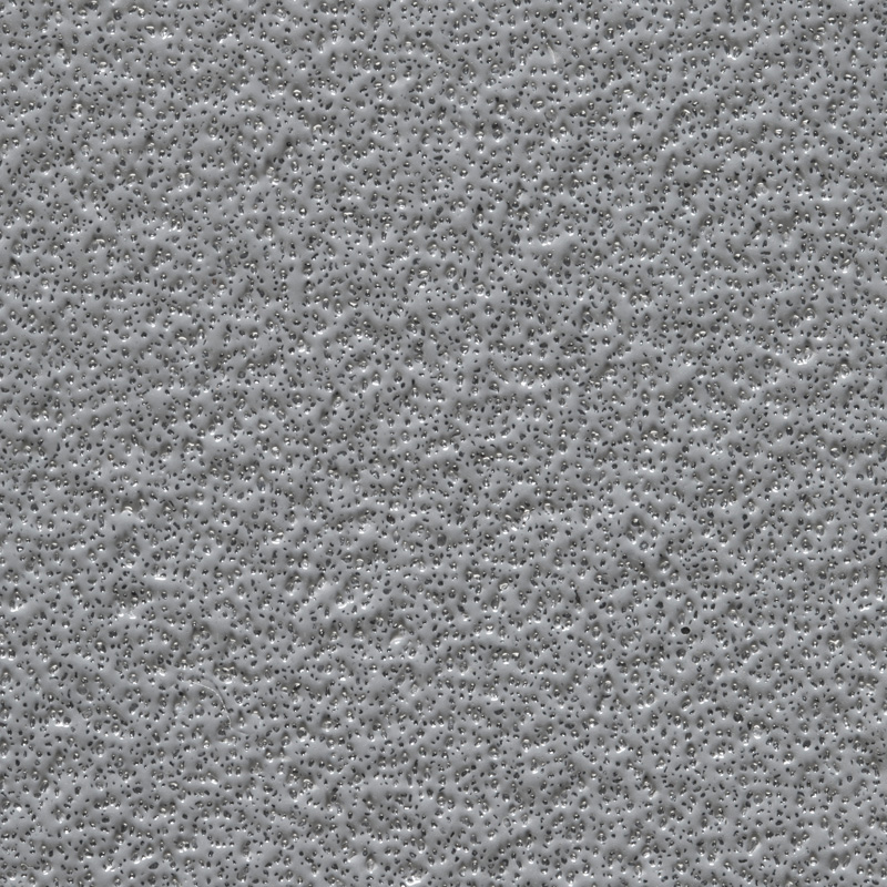 Close-up of a gray, textured surface with small, evenly distributed bumps and indentations.