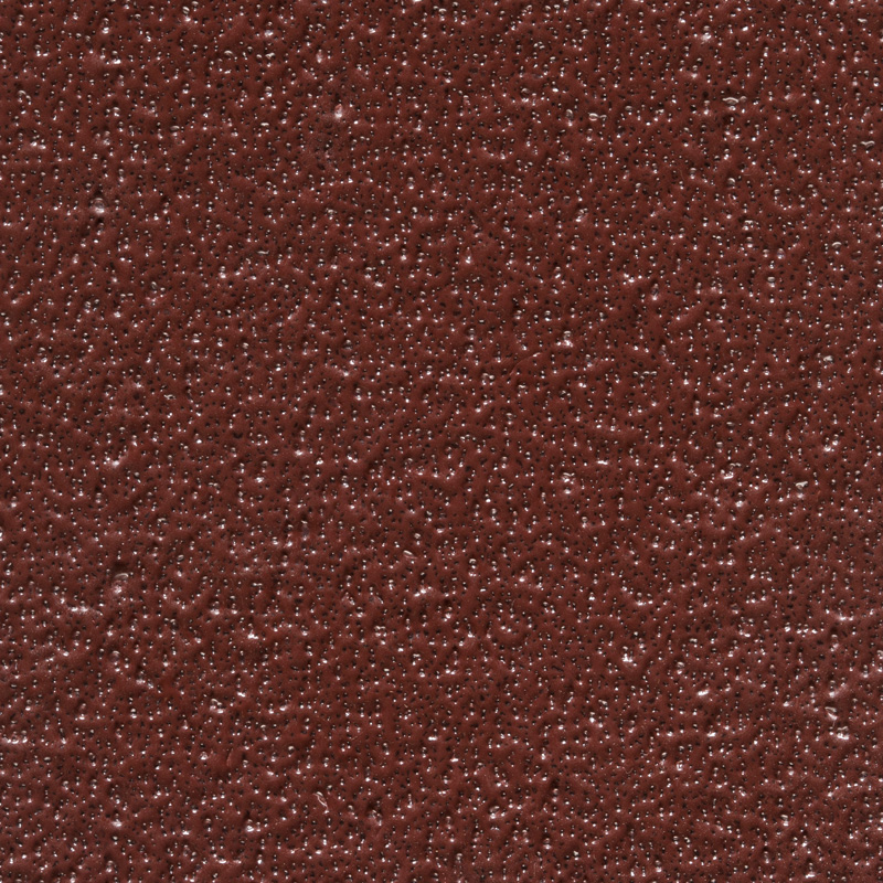 Close-up of a textured brown surface with small raised bumps and an uneven, matte finish.